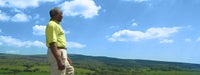 African-American senior man standing in view of mountain range
