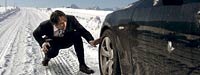 Man checking car tire