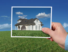 Holding a photo of a house