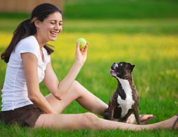Woman playing catch with dog