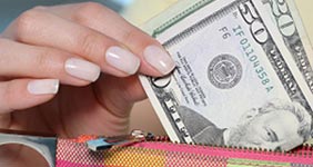 fifty dollar bill and pink wallet