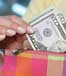 fifty dollar bill and pink wallet