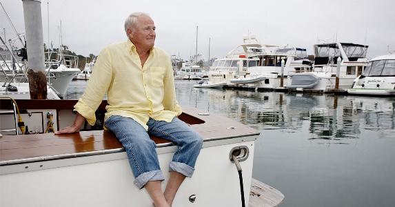 Mature man sitting on marina dock | Blend Images - Peathegee Inc/Getty Images