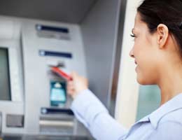8-secrets-about-your-debit-card-9-option-lg Woman using ATM