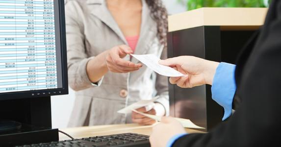 Accountant being handed a check © iStock