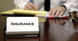 Agent with insurance card on desk © Lane V. Erickson/Shutterstock.com