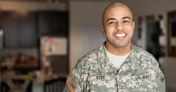 Find out: What is a VA loan? Service member smiling in his living room | Roberto Westbrook/Blend Images/Getty Images