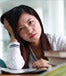 Asian student stressed over her schoolwork