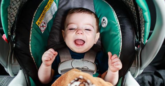 When you can move child out of infant car seat Baby in green car seat | Jamie De Pould/Moment/Getty Images