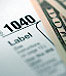A 1040 tax sheet with money on the side