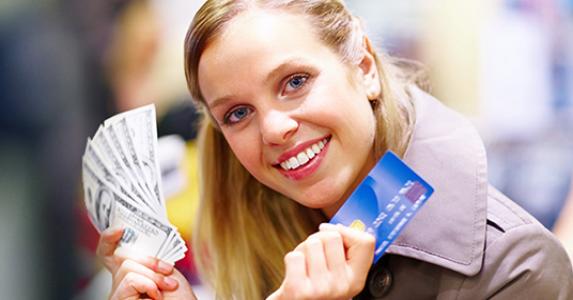 Beautiful lady holding cash and credit card © Yuri Arcurs - Fotolia.com