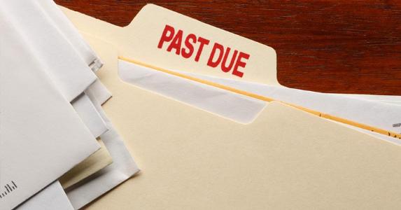 HOA dues still due after bankruptcy filing? Bills in a 'Past Due' folder © iStock