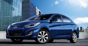 blue hyundai accent sun shining on rooftop