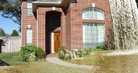 House flooding with waterfall coming from roof © Holly Jahangiri/Shutterstock.com