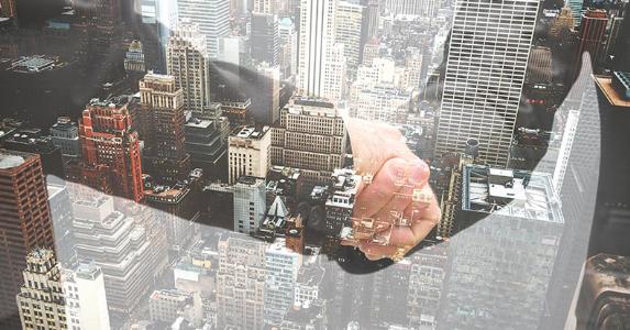 Personal loans and co-borrowers Businessmen shaking hands, window reflecting city below | franckreporter/Getty Images