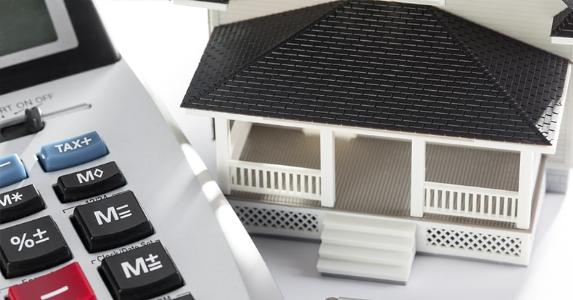 Calculator and toy house © iStock