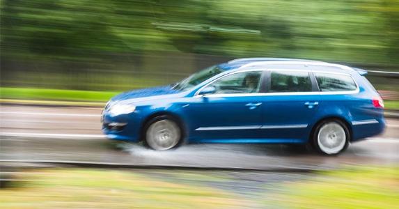 How can I prevent my car from hydroplaning? Car driving fast in the rain | Joseph O. Holmes/Getty Images