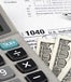 Tax form, calculator, and cash