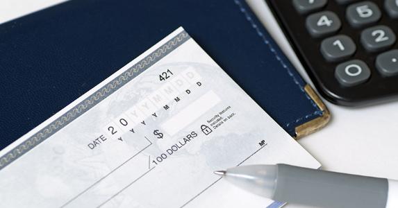 Checkbook, pen and a calculator © JJ Studio/Shutterstock.com