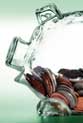 clear piggy bank half-filled with coins