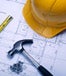 Construction hat and tools on blueprint