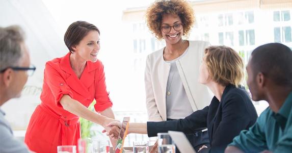 Build your investment ladder with corporate bonds Colleagues shaking hand at meeting | Caiaimage/Sam Edwards/Getty Images