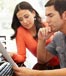couple computer looking at bills
