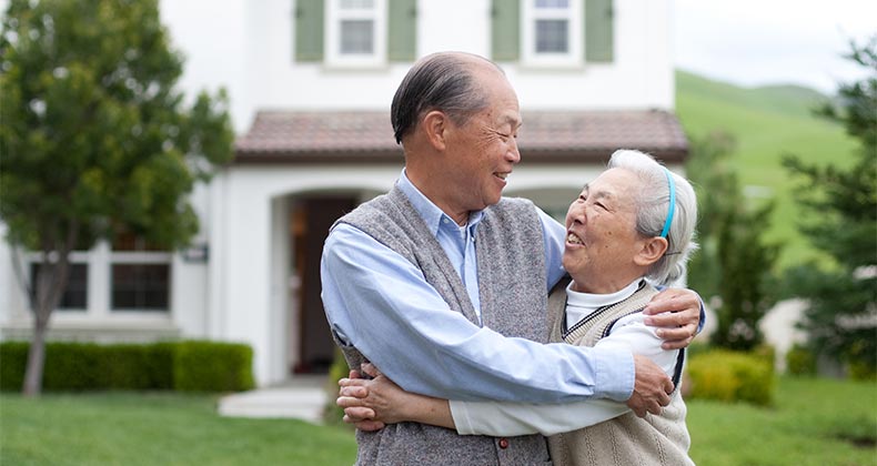 Using a reverse mortgage to pay off 1st mortgage Married couple embracing, excited © Flashon Studio/Shutterstock.com