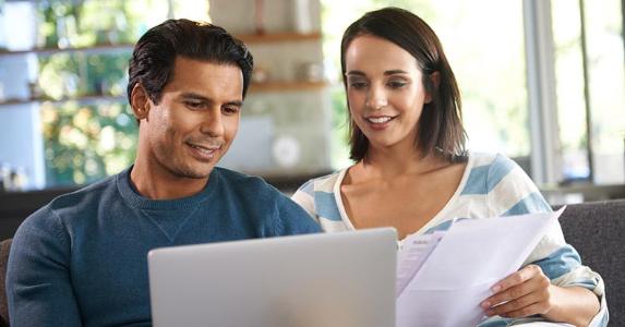 5 questions to ask before tapping home equity Couple happily budgeting together © iStock