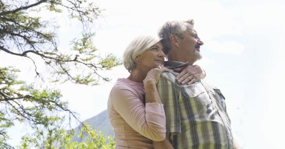 Is my Social Security at risk over VA loan? Couple standing outside under a tree | Hero Images/Getty Images