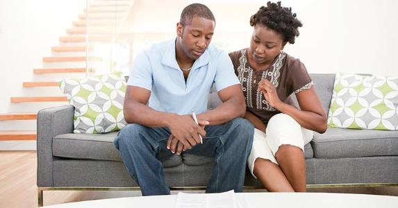 Here's when it makes sense to refinance a personal loan Couple looking over document | Noel Hendrickson/Getty Images