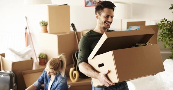 Which mortgage is for you? Conventional, FHA, VA Couple unpacking moving boxes | gpointstudio/Shutterstock.com