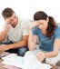 worried couple reviewing paperwork