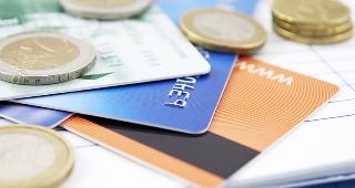 Credit cards and world coins © pgaborphotos/Shutterstock.com