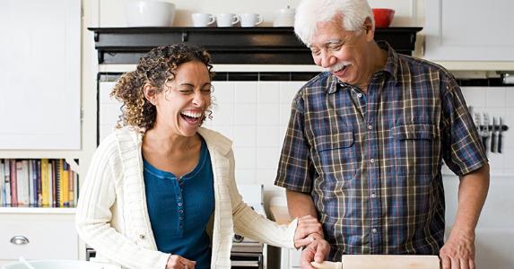 Reverse mortgage loan: What about your kids and heirs? Family laughing in kitchen | Image Source/Getty Images