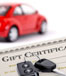 car keys and gift certificate with blurry red car in the distance