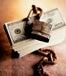 A rusty lock on top of a stack of 100 dollar bills