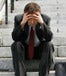 depressed businessman on concrete stairs