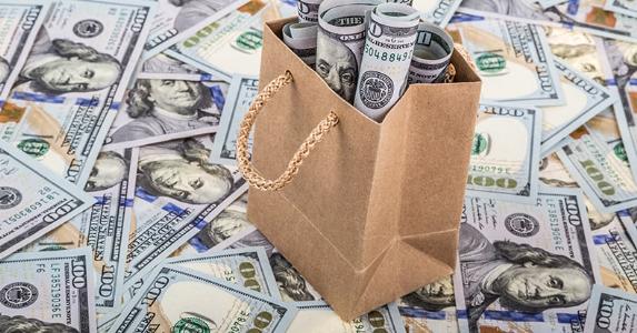 2014-2015 estate tax and gift tax amounts Dollars in a brown paper shopping bag © berna namoglu/Shutterstock.com