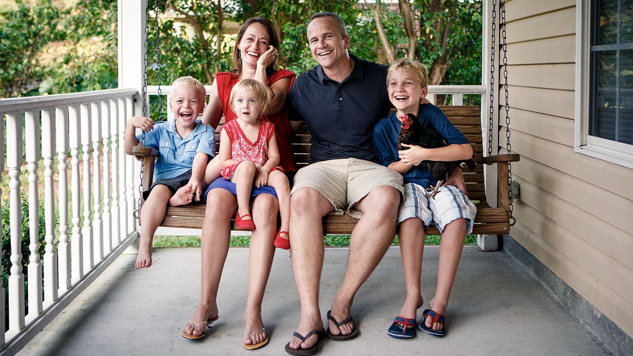 Drawbacks of refinancing into a 15-year mortgage Family sitting on front porch swing | Stephen W. Morris/Getty Images