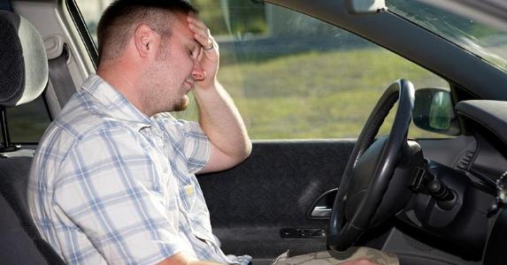 Driver sitting sadly in his car © iStock