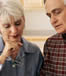 elderly couple analyze documents