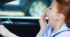 Exhausted woman in car yawning © PathDoc/Shutterstock.com