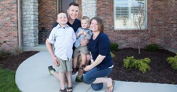 Family posing outside of home in walkway | Veterans United