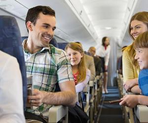 Family sitting together in plane | Hero Images/Getty Images