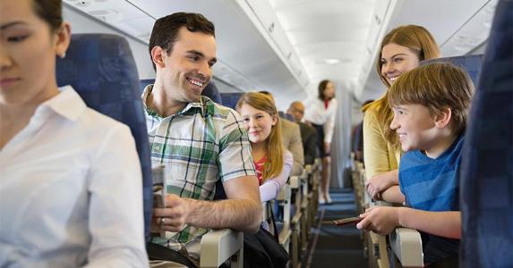 Family sitting together in plane | Hero Images/Getty Images