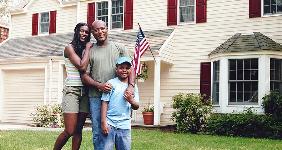 Family standing outside home | Cohen/Ostrow/Digital Vision/Getty Images