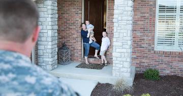 Family waiting at front door for returning serviceman | Veterans United