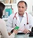Female patient giving doctor credit card auremar/Shutterstock.com