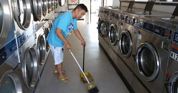 Frank Ahn sweeping laundromat | Photo courtesy of Frank Ahn